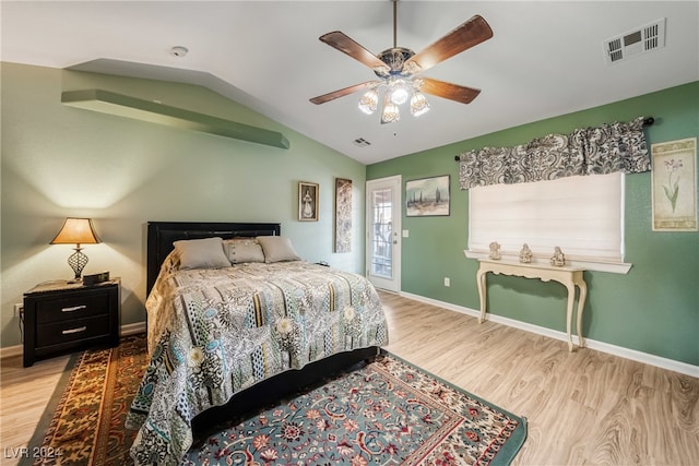 bedroom featuring light wood-type flooring, lofted ceiling, and ceiling fan