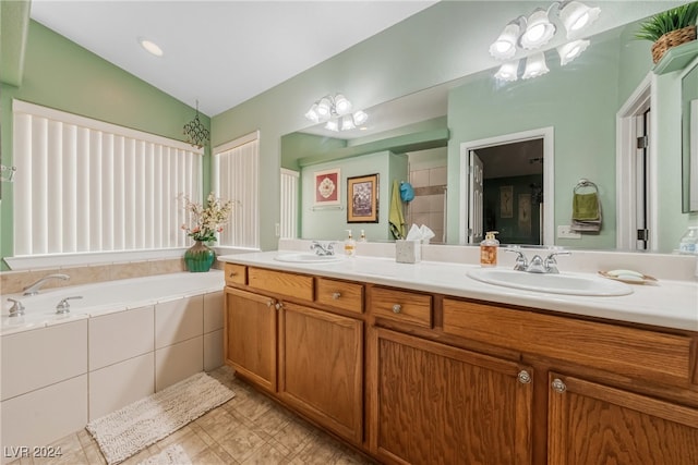 bathroom featuring an inviting chandelier, tiled tub, vanity, and lofted ceiling