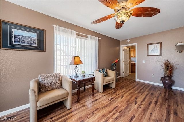 sitting room featuring ceiling fan and wood-type flooring