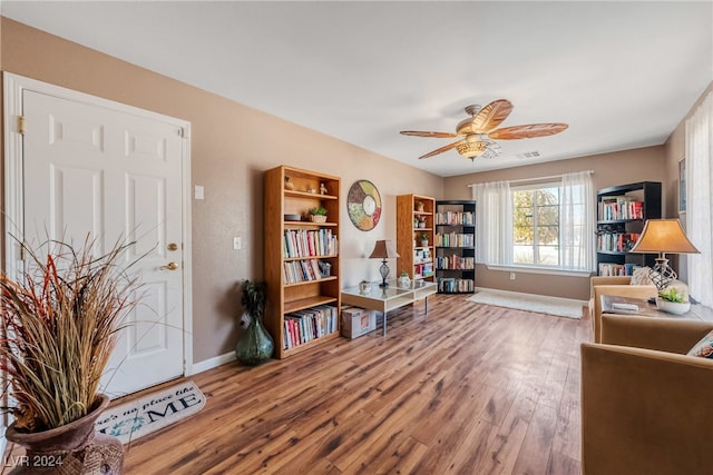 living area with ceiling fan and hardwood / wood-style flooring