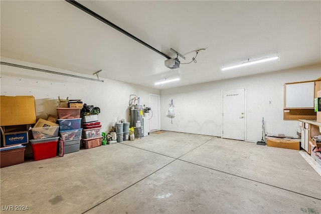 garage with electric water heater and a garage door opener