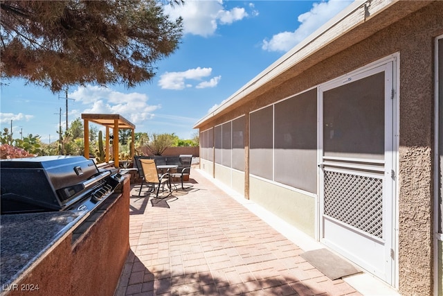 deck with grilling area, a sunroom, and a patio