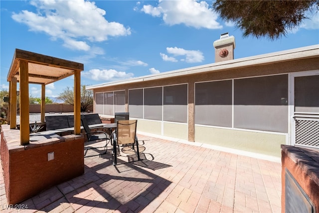 view of patio with a sunroom