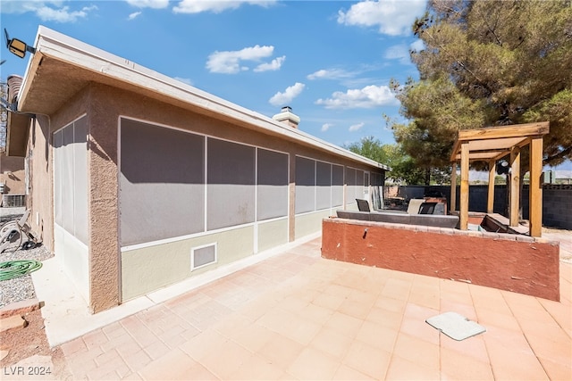 view of patio featuring a sunroom