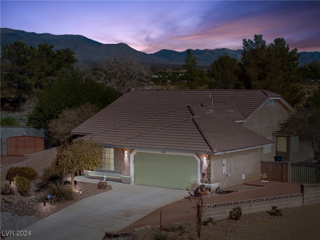 view of front of property featuring a mountain view and a garage