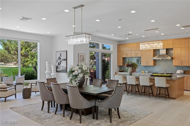 dining area featuring a chandelier and light tile patterned floors