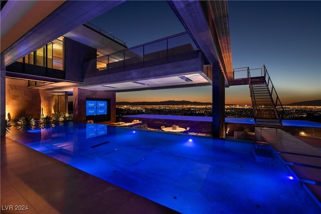 pool at dusk with pool water feature