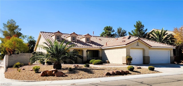 mediterranean / spanish-style home featuring a garage