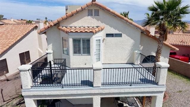 back of house featuring a balcony