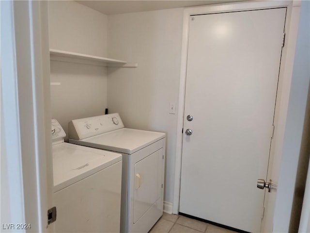 washroom with washer and clothes dryer and light tile patterned floors