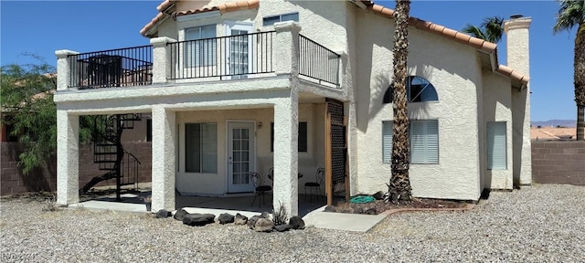 back of house with a patio area and a balcony