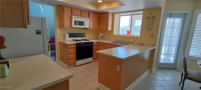 kitchen with kitchen peninsula, sink, light tile patterned flooring, and white appliances