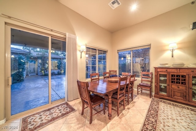 tiled dining space with vaulted ceiling