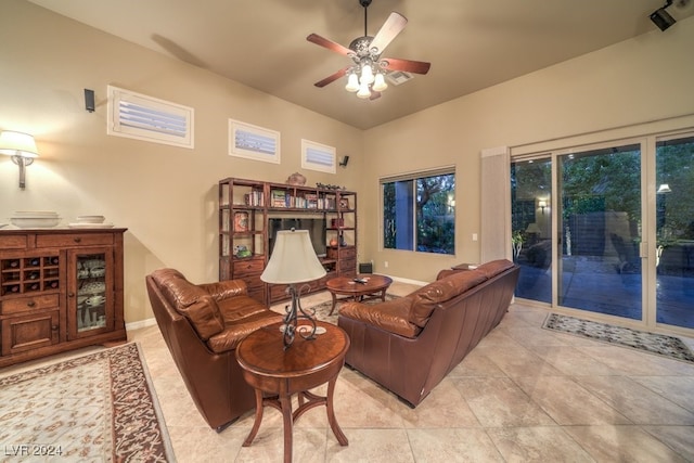 living room featuring ceiling fan and light tile patterned floors