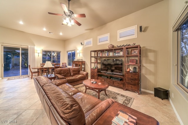 tiled living room with ceiling fan