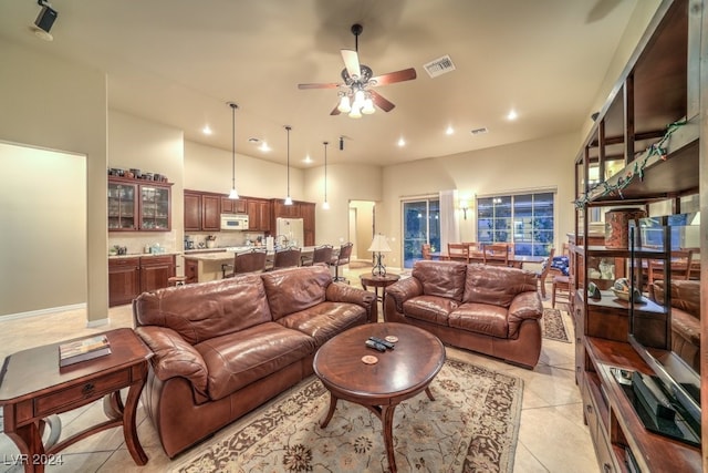 tiled living room with ceiling fan