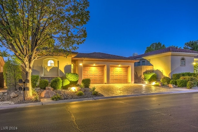 mediterranean / spanish-style house with a garage