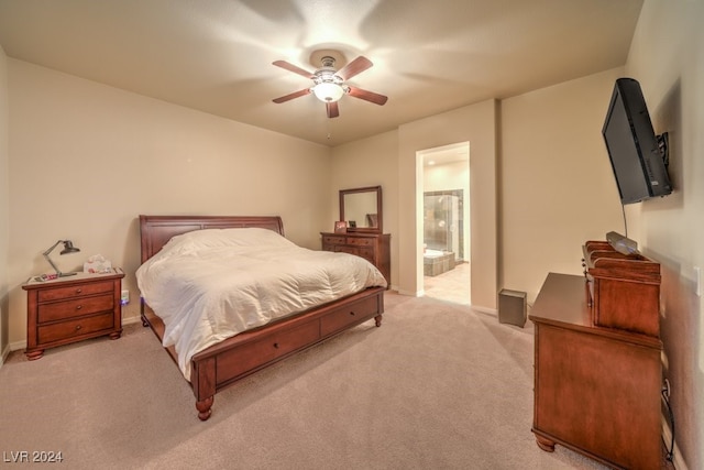 carpeted bedroom featuring ceiling fan and ensuite bath