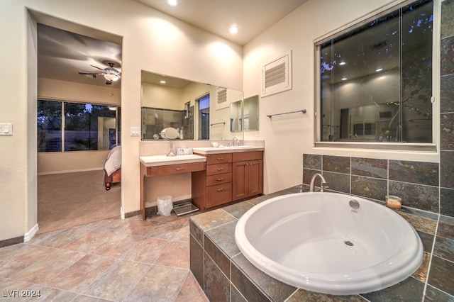 bathroom with ceiling fan, vanity, and separate shower and tub