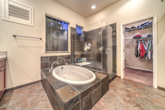 bathroom featuring vanity and separate shower and tub