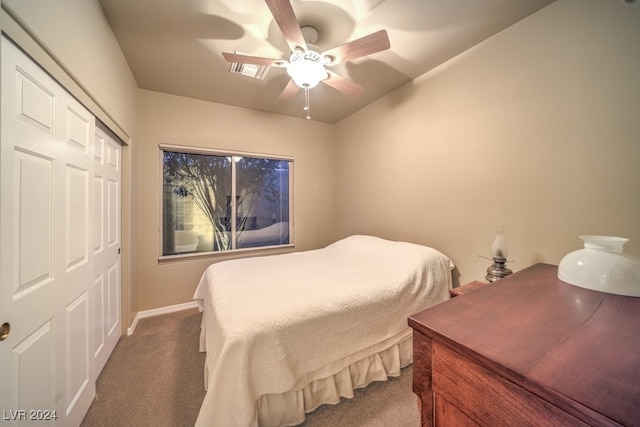 carpeted bedroom featuring ceiling fan and a closet