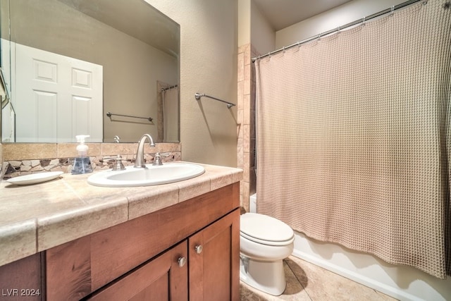 full bathroom featuring vanity, shower / bath combo with shower curtain, toilet, and tile patterned flooring