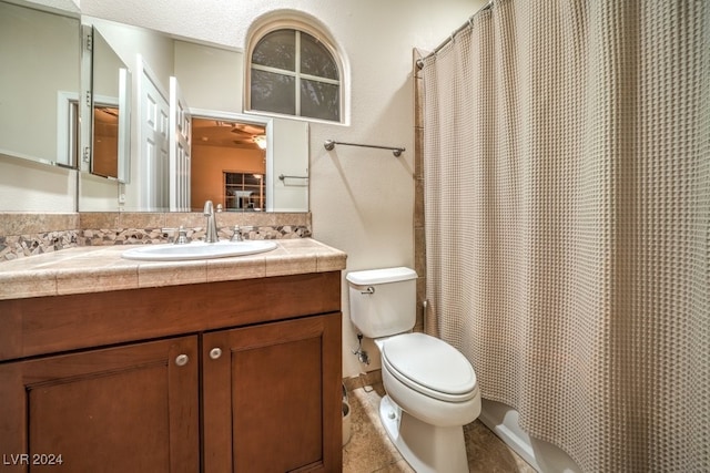 bathroom with vanity, toilet, and tile patterned floors