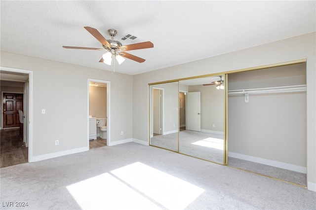 unfurnished bedroom with carpet floors, a textured ceiling, ceiling fan, and a closet