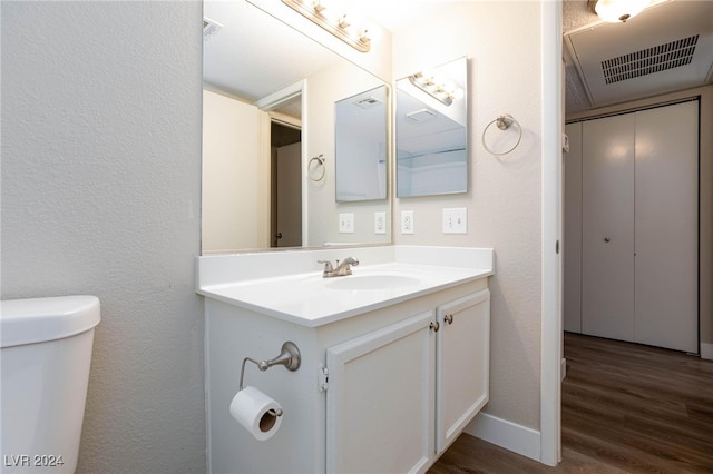 bathroom featuring hardwood / wood-style flooring, vanity, and toilet