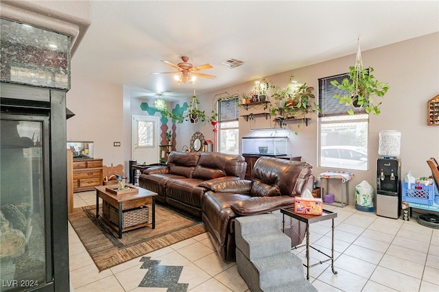 living room featuring light tile patterned floors, plenty of natural light, and ceiling fan