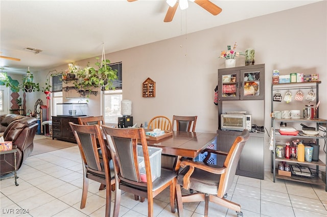 tiled dining room with ceiling fan