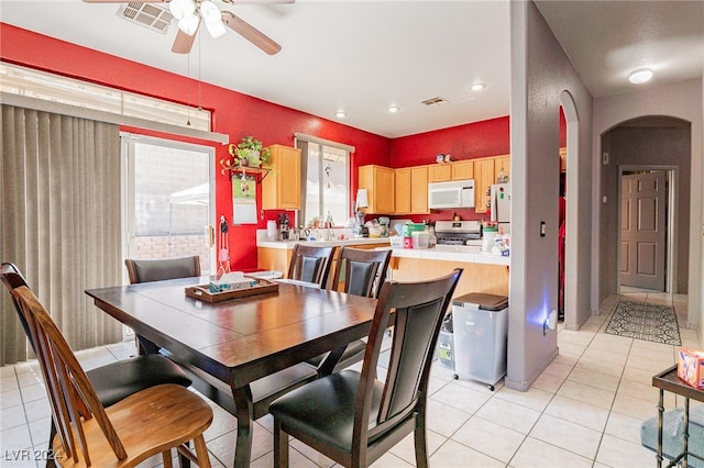 dining room with ceiling fan and light tile patterned flooring