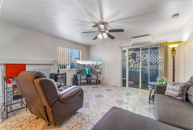 tiled living room featuring a textured ceiling, a wall mounted AC, and ceiling fan