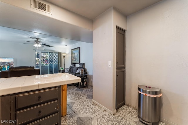 interior space with tile patterned flooring and ceiling fan