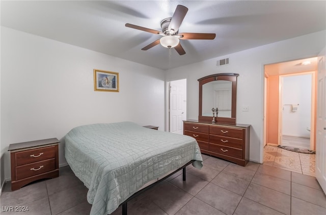 bedroom with connected bathroom, ceiling fan, and light tile patterned floors