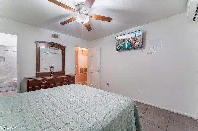 tiled bedroom with ceiling fan, ensuite bath, and a wall mounted AC