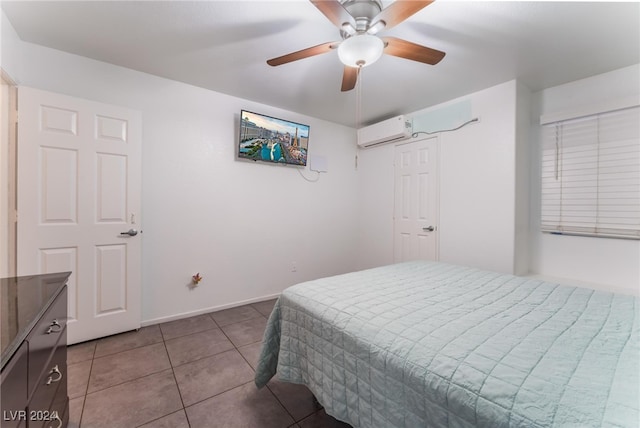 bedroom with ceiling fan, a wall unit AC, and tile patterned floors