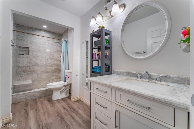 bathroom with a shower with curtain, vanity, hardwood / wood-style floors, and toilet