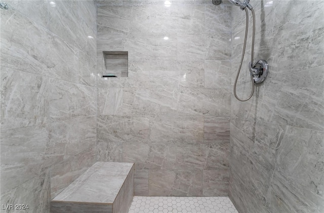 bathroom with a tile shower