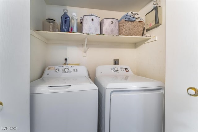 washroom with washing machine and clothes dryer