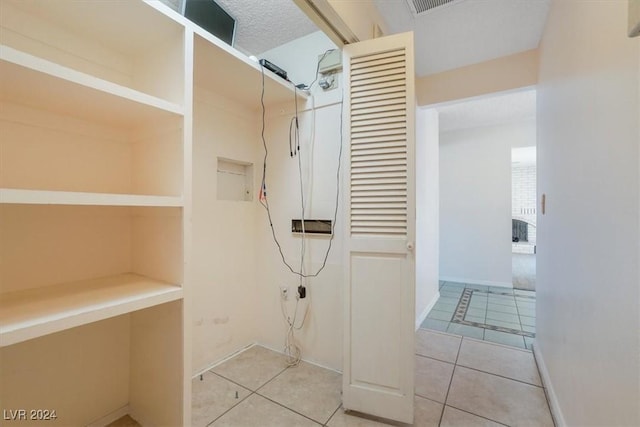 bathroom with tile patterned floors and a textured ceiling