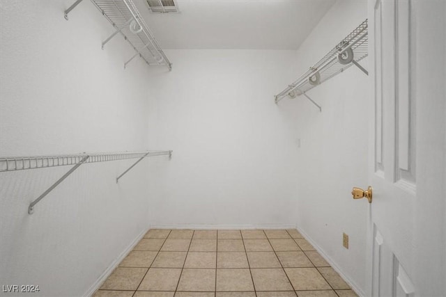 spacious closet featuring light tile patterned floors