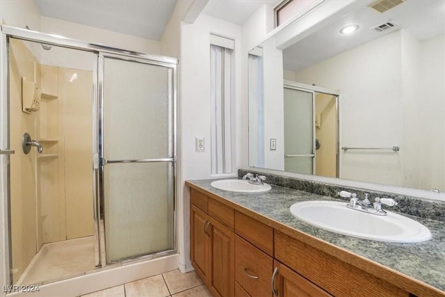 bathroom featuring tile patterned floors, an enclosed shower, and vanity