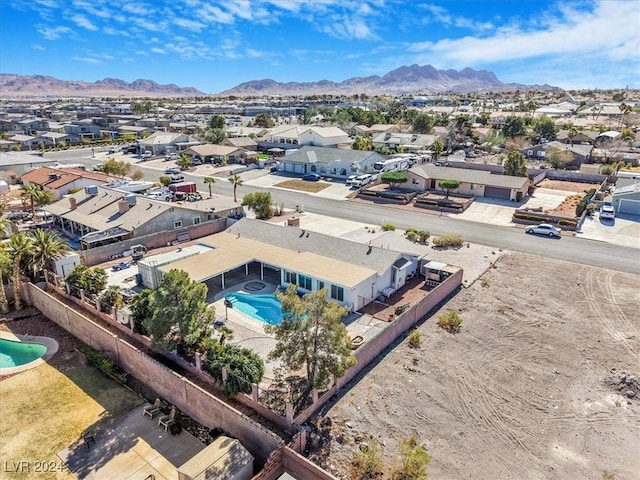 birds eye view of property with a mountain view