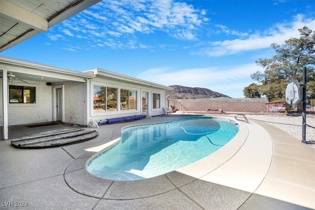 view of pool featuring a patio and a mountain view