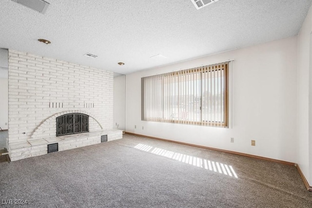 unfurnished living room with a fireplace, carpet floors, and a textured ceiling