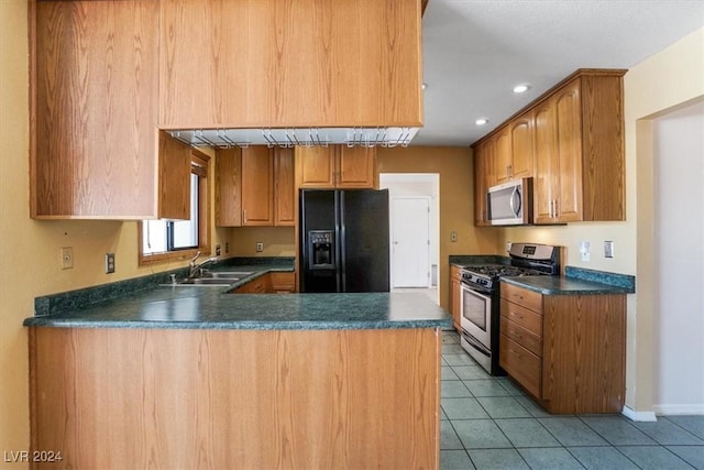 kitchen featuring sink, kitchen peninsula, light tile patterned flooring, and stainless steel appliances