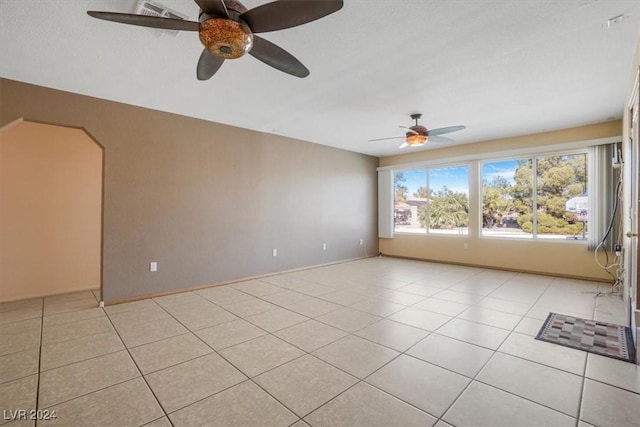 spare room featuring ceiling fan and light tile patterned floors