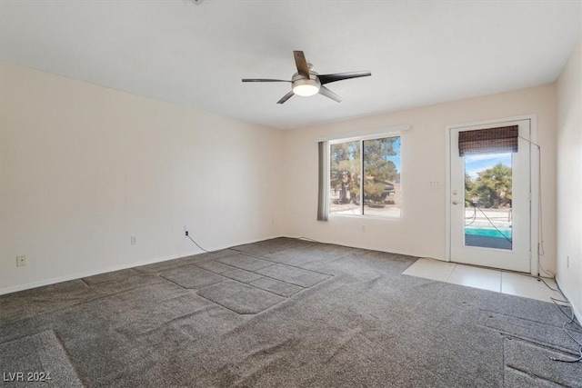 carpeted spare room with ceiling fan