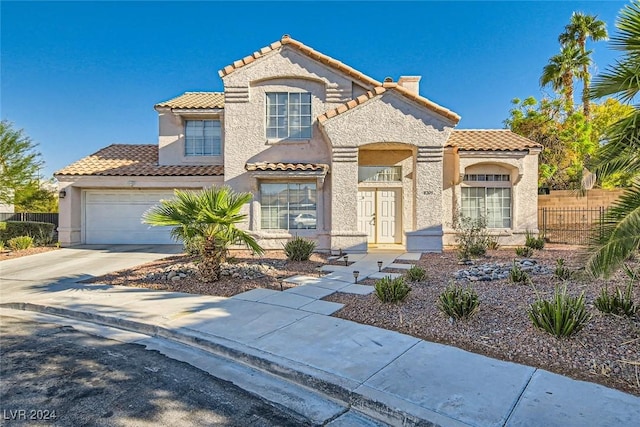 mediterranean / spanish-style home with a garage